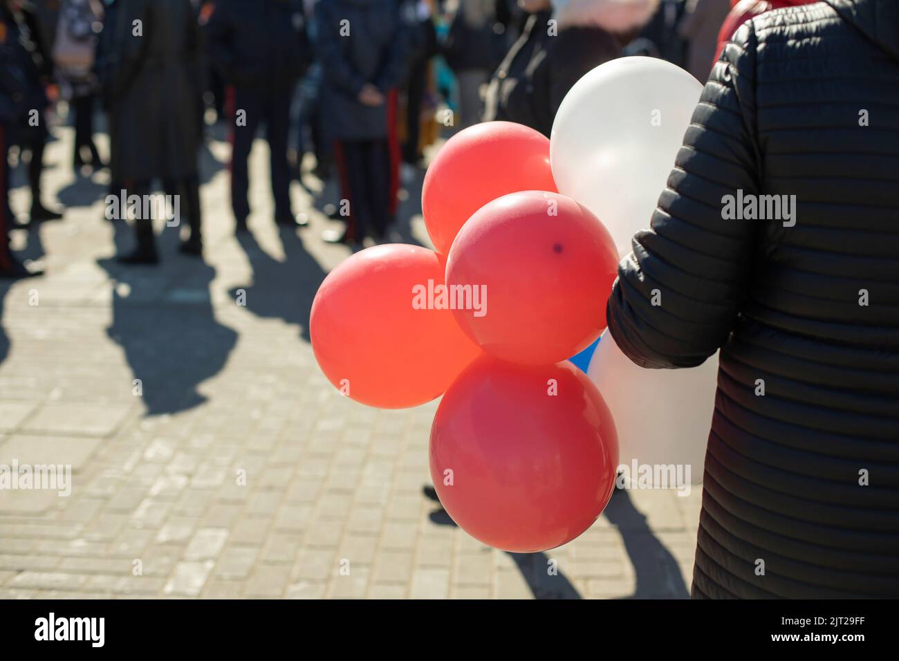 Balloons in hand. Balls at festival. Inflatable balloons in detail. Stock Photo