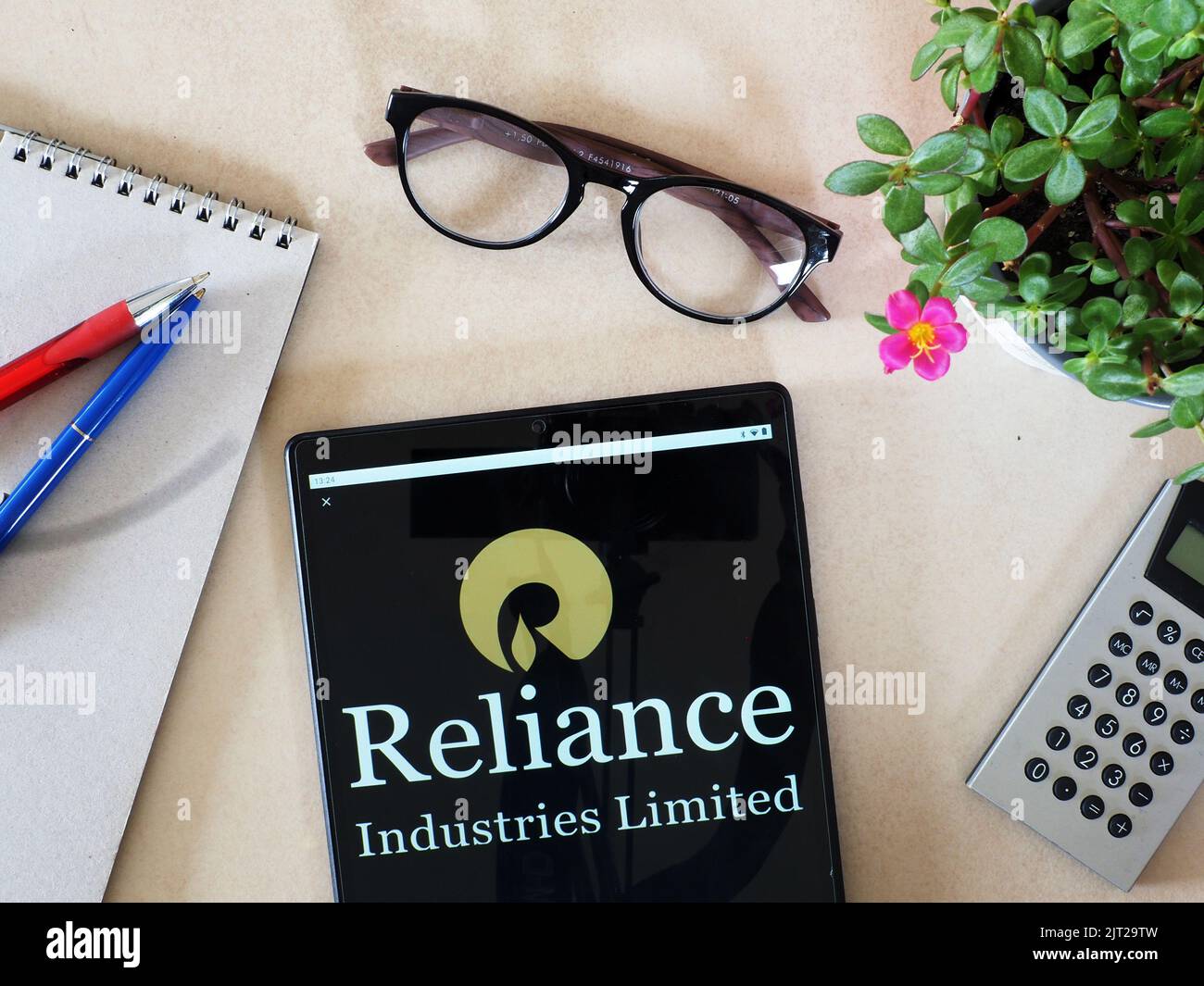 In this photo illustration, a Reliance Industries Limited logo seen displayed on a tablet. Stock Photo