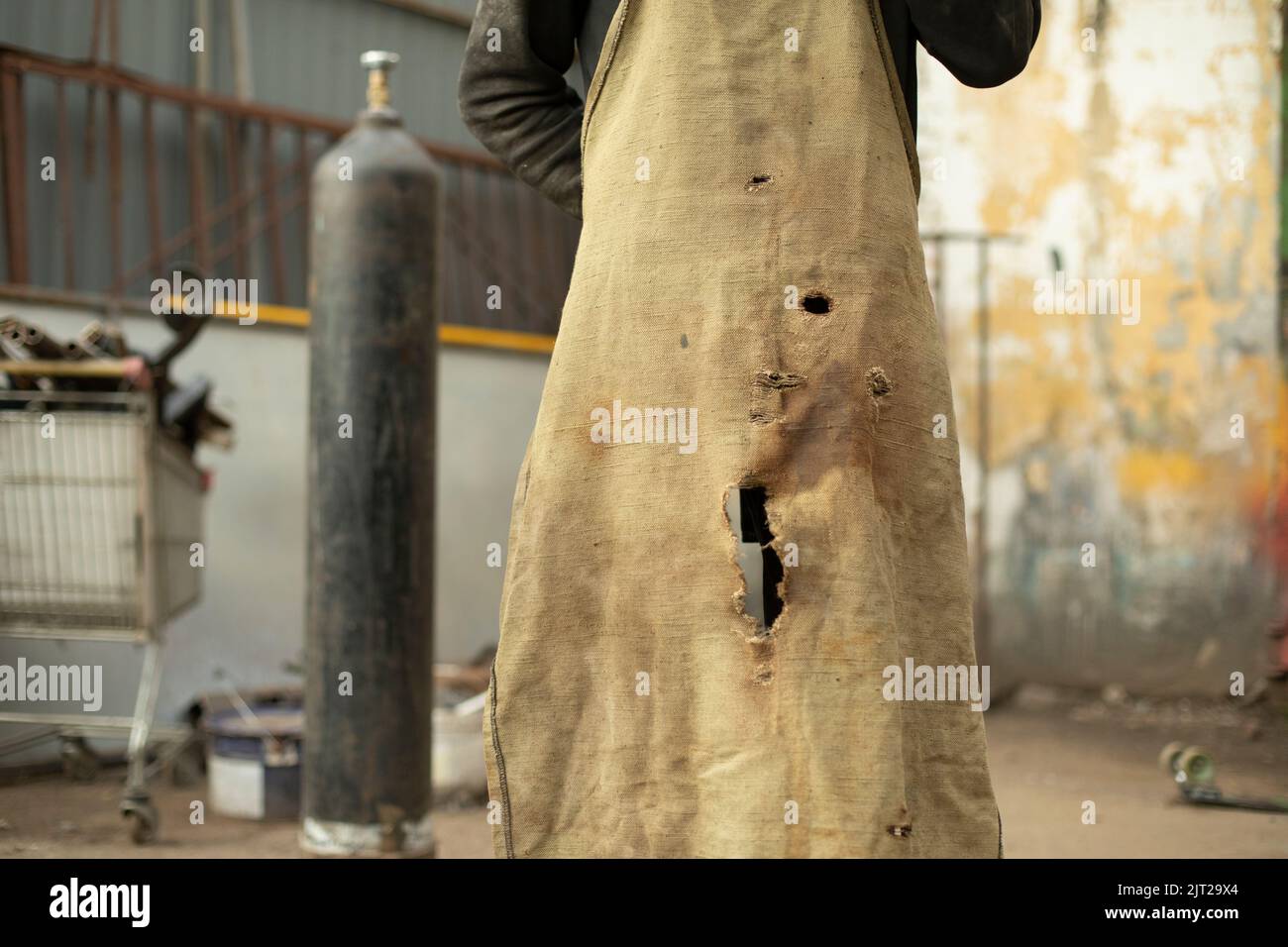 Old apron. Work clothes. Torn piece of cloth. Apron in holes. Details ...