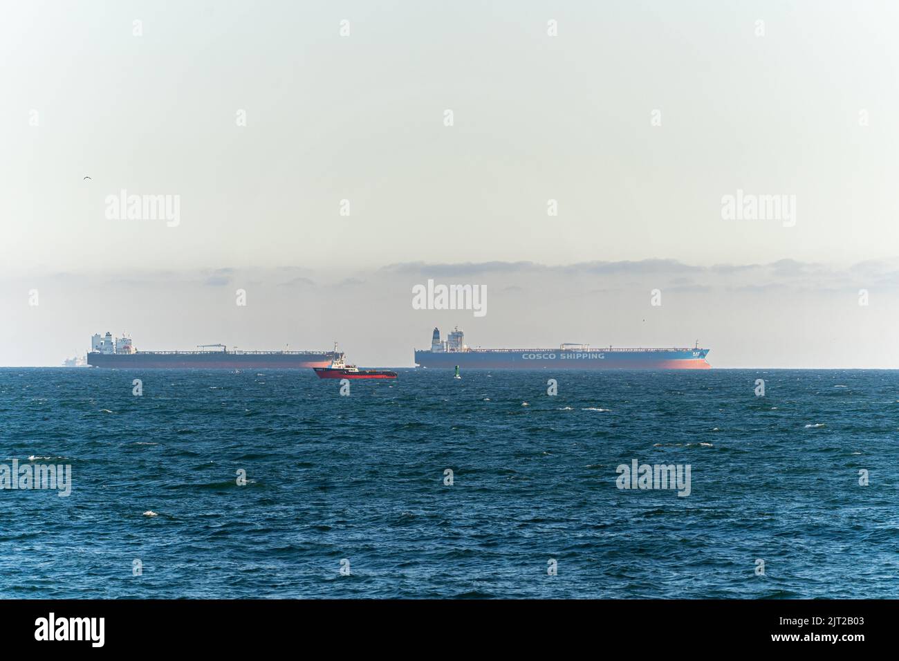 A line of cargo ships waiting to get into port of Long Beach Stock