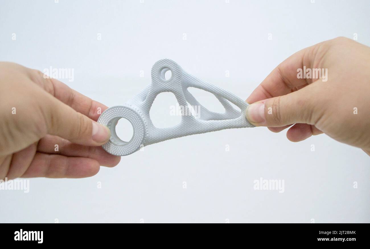 Person holding plastic model printed on powder 3d printer from powder ...