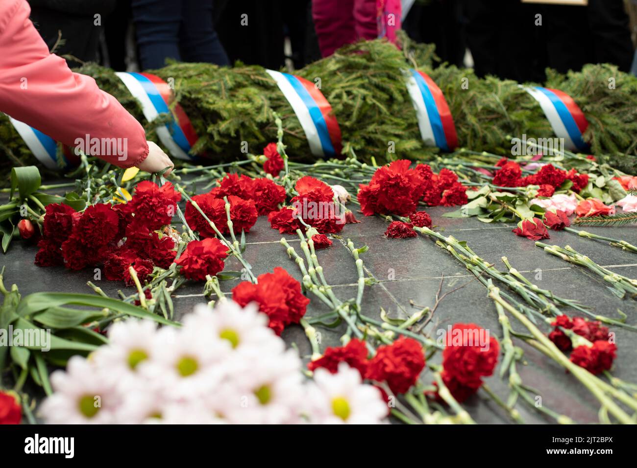 Flowers on grave of soldier in Russia. Details of funeral ceremony at