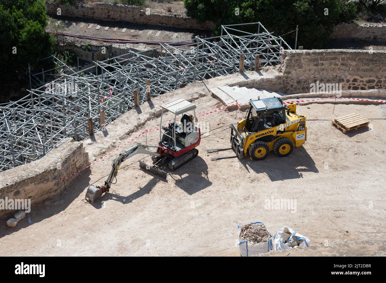 A drone view of a mini excavator and a skid steer loader at the construction site Stock Photo