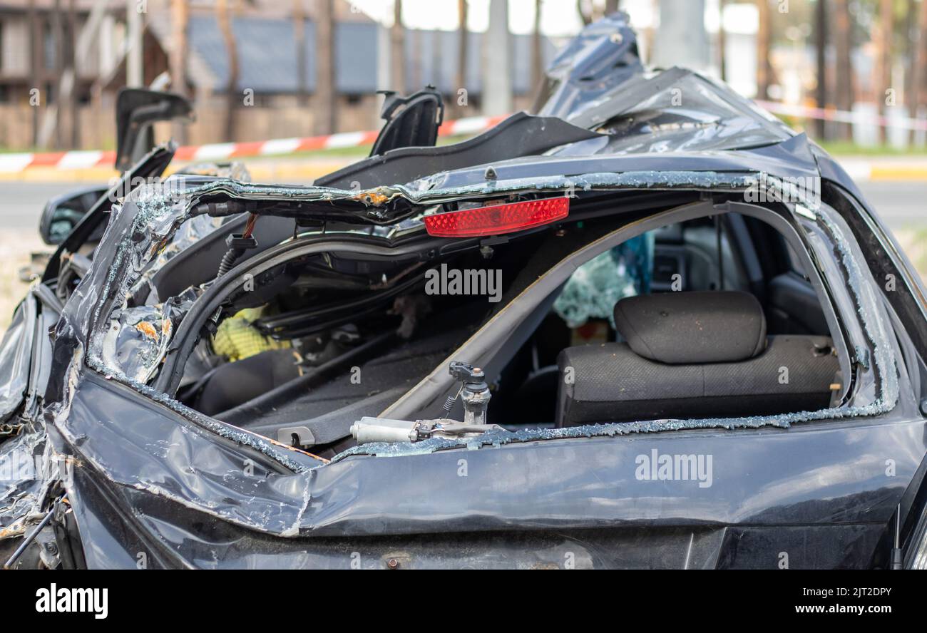 Shot car during the war in Ukraine. A car after an accident with a broken rear window. The wreckage of the interior of a modern car after an accident Stock Photo