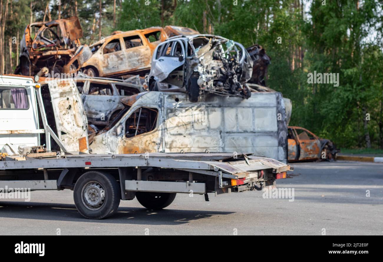 Lots of old cars ready for recycling. Car removal by tow truck. Damaged