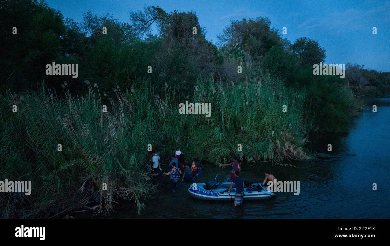 Migrant families enter the Unites States after being smuggled across the Rio Grande river from Mexico into Roma, Texas, U.S., August 26, 2022.  REUTERS/Adrees Latif Stock Photo