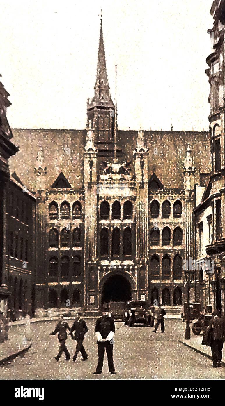 OLD LONDON -A vintage photo showing an English Bobby (Policeman) on traffic duty outside of the Guildhall which   has been used as a town hall for hundreds of  years, and is   the ceremonial and administrative centre of the City of London. Both the building and its Great Hall carry the name GUILDHALL. The remains of a Roman amphitheatre were discovered here in 1988. Stock Photo