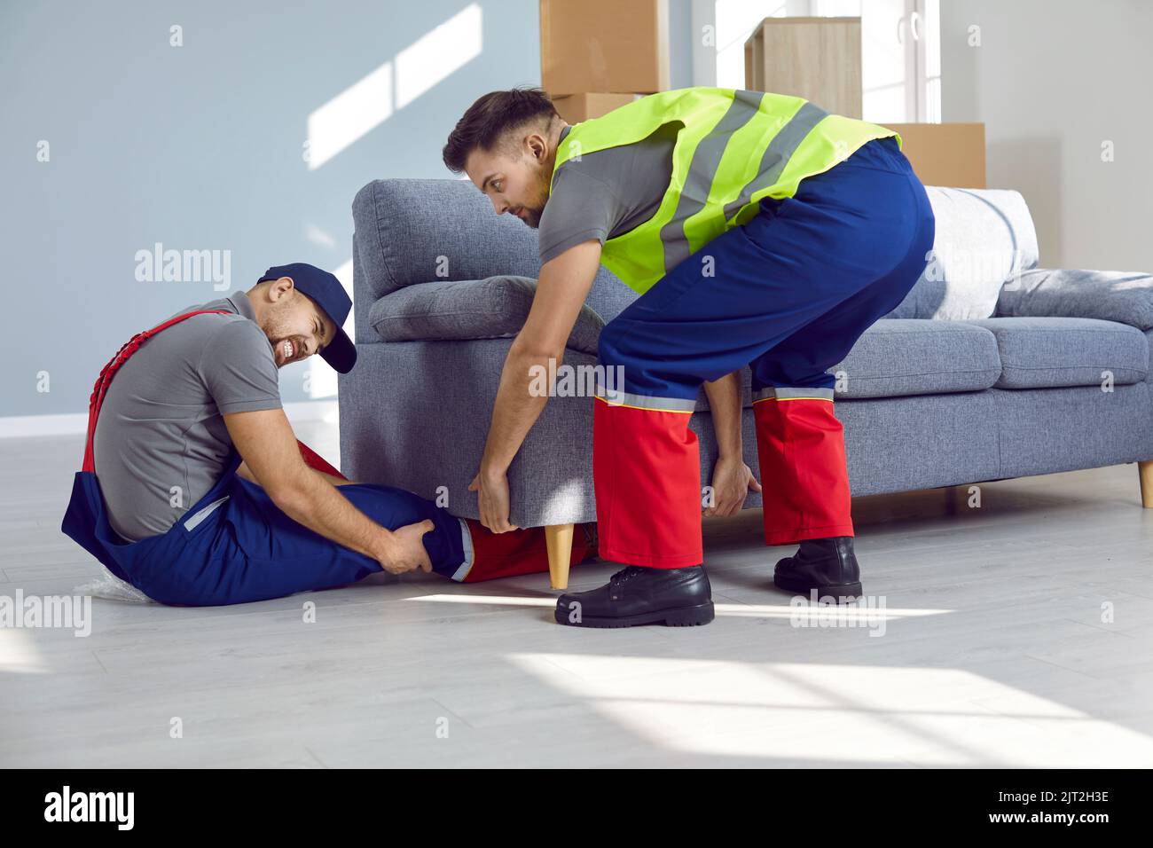 https://c8.alamy.com/comp/2JT2H3E/one-of-the-loaders-gets-his-leg-broken-while-removing-heavy-couches-from-the-house-2JT2H3E.jpg