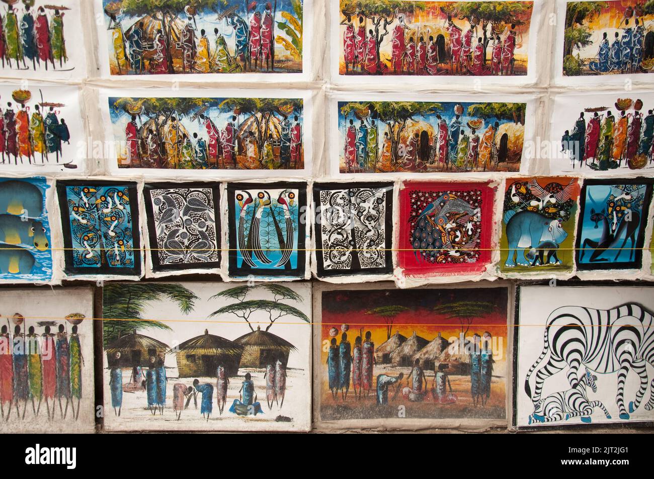 Paintings of Masai andsome Arican animals, on Sale at Mwenge Carvers' Market, Mwenge, Dar-es-Salaam, Tanzania, Africa.  Mwenge is a suburb of Dar-es-S Stock Photo