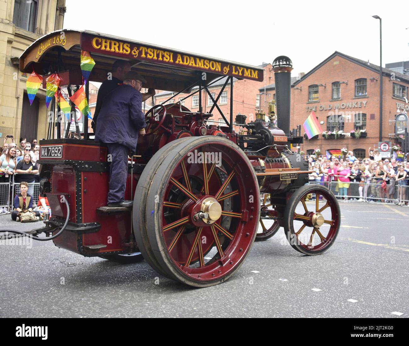 Manchester, UK. 27th August, 2022. A steam powered wagon carries text: 'Chris and Tsitsi Adamson of Lymm'.  Participants take part in the LGBTQ+ Pride parade, central Manchester, UK, as LGBTQ+ Pride continues over the Bank Holiday weekend 26th to 29th August. Organisers say: 'Manchester Pride is one of the UK's leading LGBTQ+ charities. Our vision is a world where LGBTQ+ people are free to live and love without prejudice. We’re part of a global Pride movement celebrating LGBTQ+ equality and challenging discrimination.' Credit: Terry Waller/Alamy Live News Stock Photo