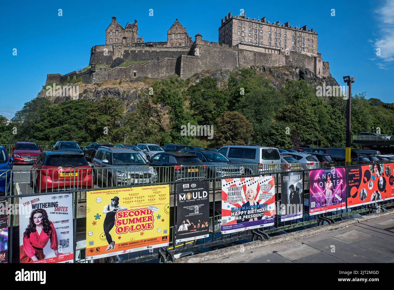 Fringe posters on the railings of Castle Terrace car park with Edinburgh Castle in the background. Stock Photo