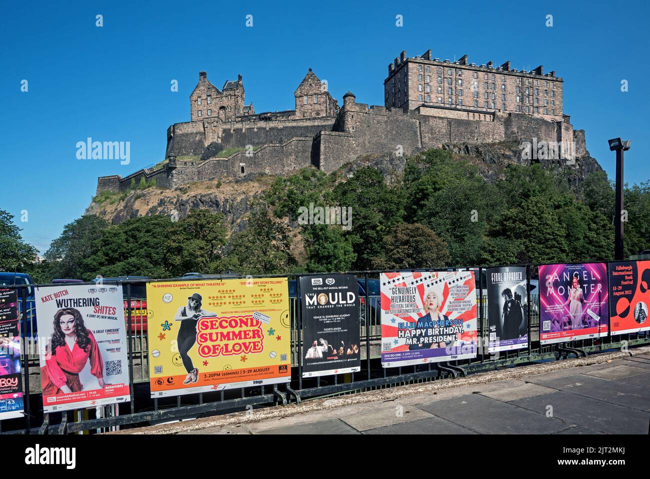 Fringe posters  on railings in Castle Terrace with Edinburgh Castle in the background. Stock Photo