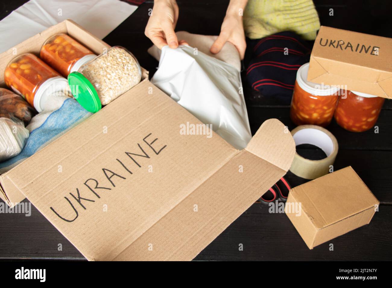 Collecting a humanitarian food set to help people who suffered during the war at the hands of Russia, stop the war in Ukraine, humanitarian aid 2022 Stock Photo