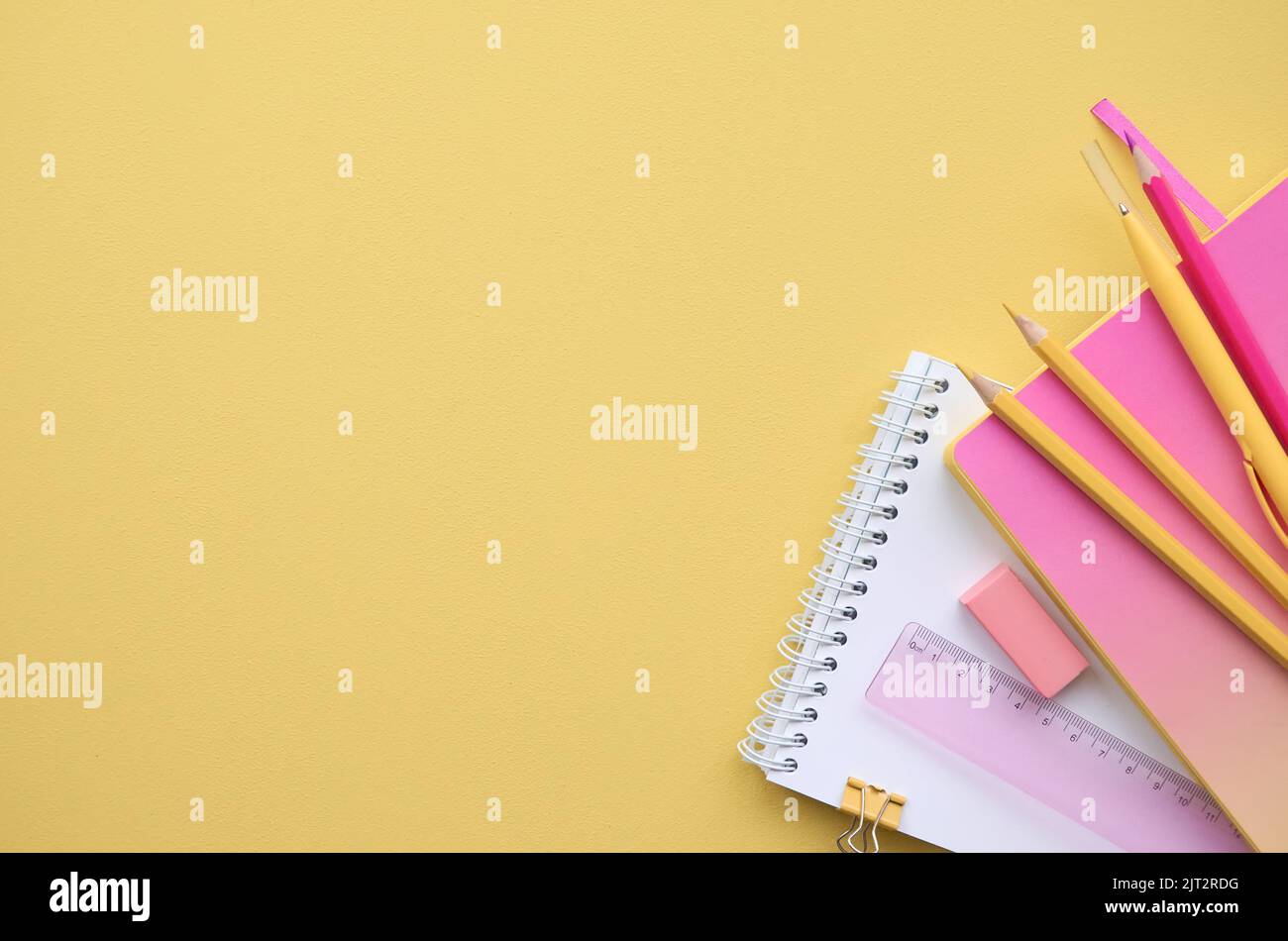 School stationery supplies on yellow pink background, flatlay. Back to school Stock Photo