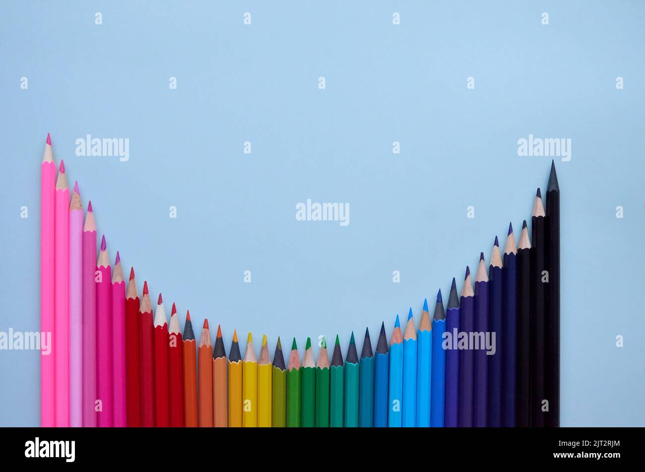 Many color pencils wave on grey background, flatlay. Back to school Stock Photo