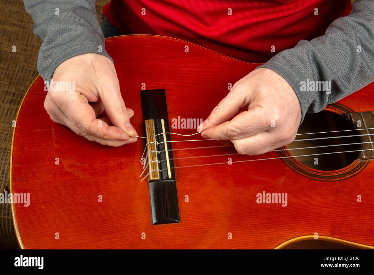 replacement and insertion of nylon strings in a classical guitar