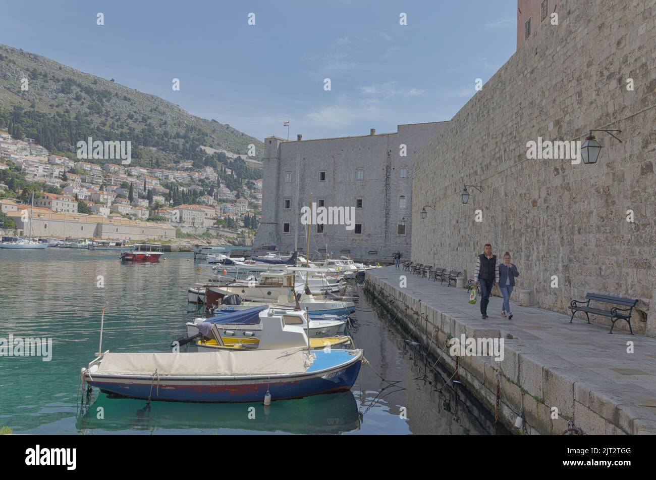 Dubrovnik old town harbor atmosphere with local small boats moored Stock Photo