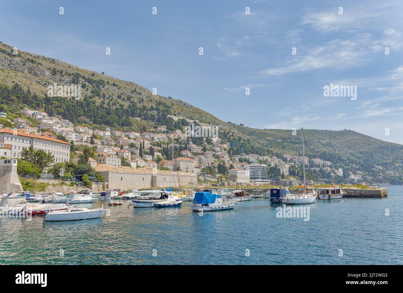 Dubrovnik old town harbor atmosphere with local small boats moored Stock Photo