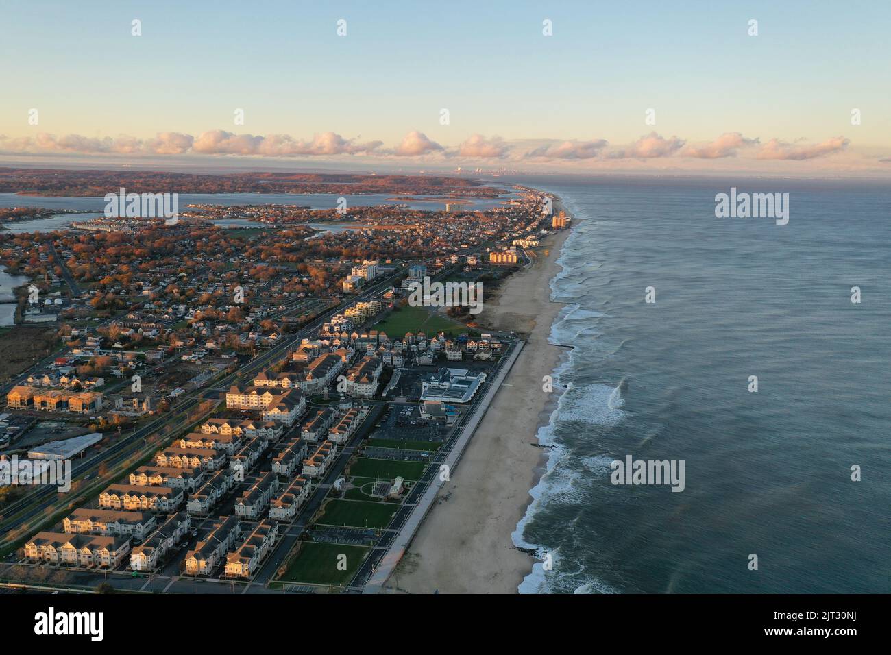 A drone shot of Sea Bright, New Jersey, and the Atlantic Ocean at sunset Stock Photo