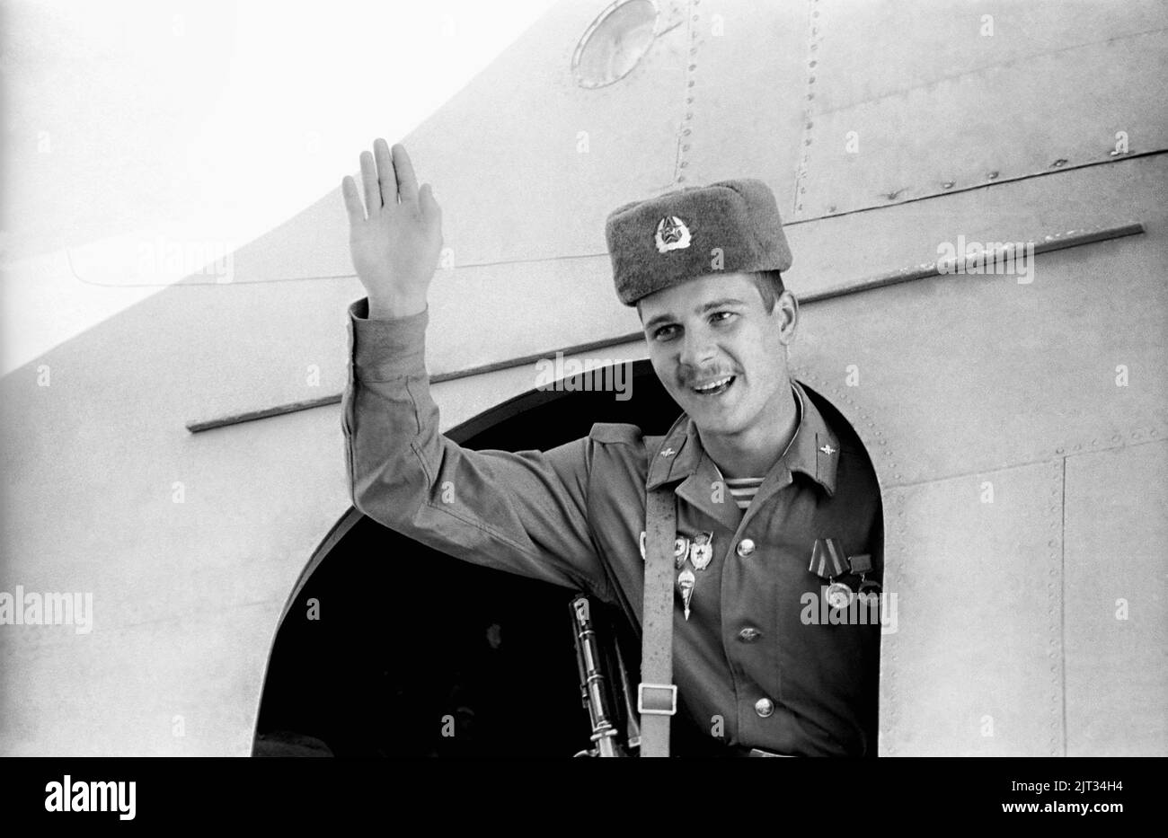 The last Soviet soldier to leave Afghanistan waves from the military transport plane at Kabul Airport, February 13, 1989 in Kabul Afghanistan. The Soviet Union pulled out the last troops ending the ten year Soviet occupation of Afghanistan. Stock Photo