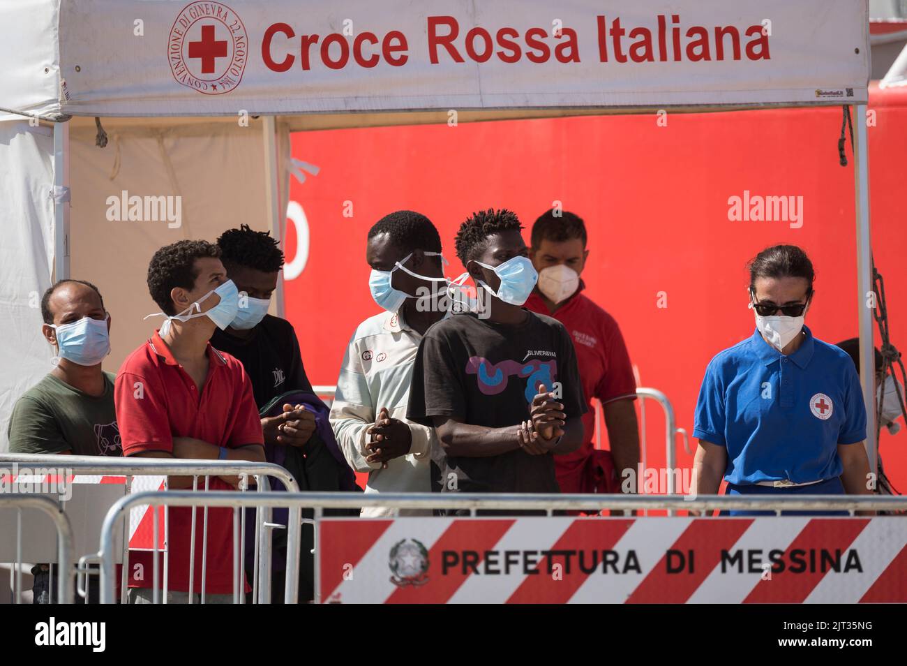 Migrants seen chatting while waiting for others to disembark. The new ...
