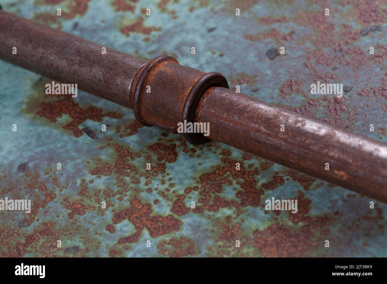 Old rusty valve pipes on rusty metal wall background Stock Photo - Alamy