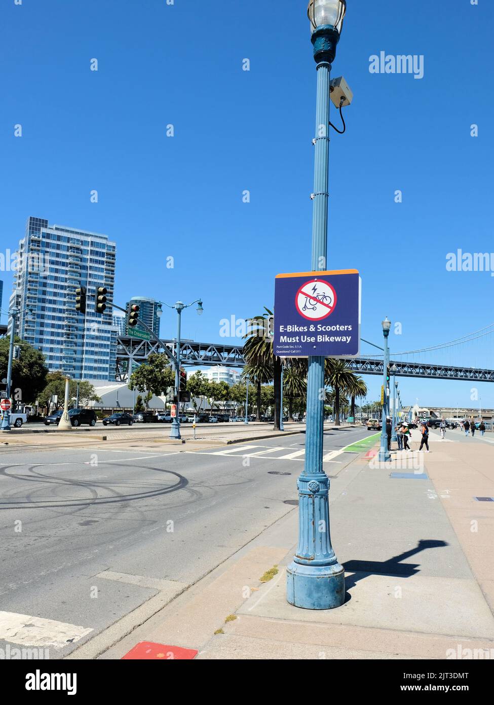A street sign warning e-bikes and scooters to not ride on sidewalk in San Francisco, California's Embarcadero roadway; use bike path or bikeway. Stock Photo