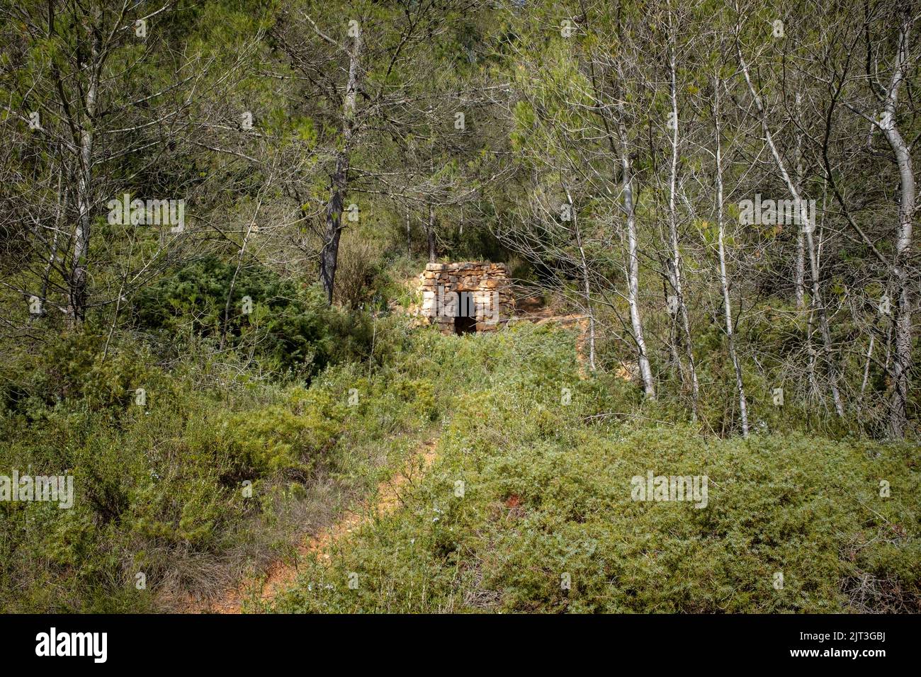 A stone hut in southern France scrubland with no people seen from afar Stock Photo