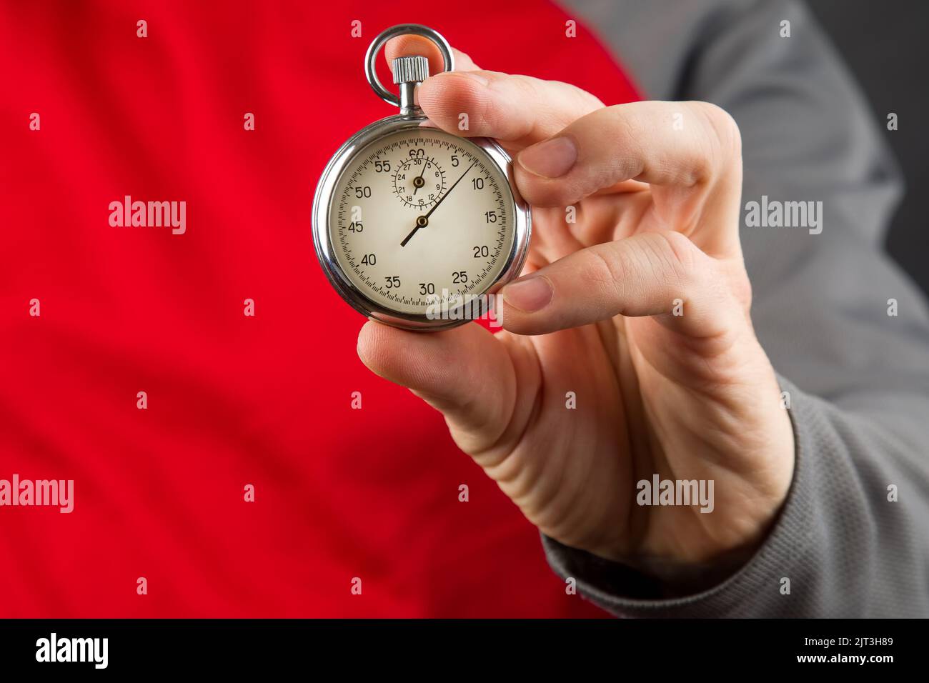 mechanical stopwatch in hand. Time part precision. Measuring the speed