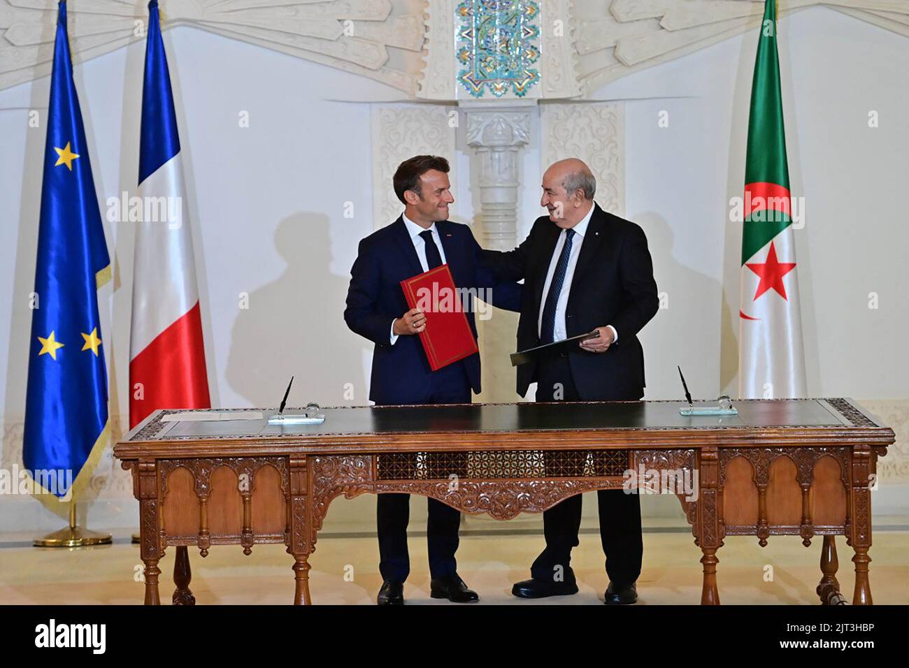 (220827) -- ALGIERS, Aug. 27, 2022 (Xinhua) -- Algerian President Abdelmadjid Tebboune (R) and French President Emmanuel Macron attend a signing ceremony in Algiers, Algeria, on Aug. 27, 2022. Algeria and France on Saturday signed a joint declaration for a 'renewed partnership' at the end of the three-day visit of French President Emmanuel Macron. (Algerian Presidency/Handout via Xinhua) Stock Photo