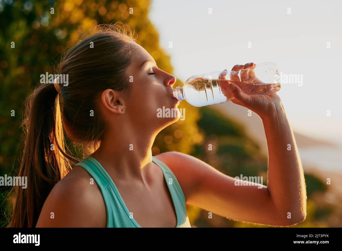 Hydration Is An Important Part Of Running An Attractive Young Woman Getting A Drink During Her 