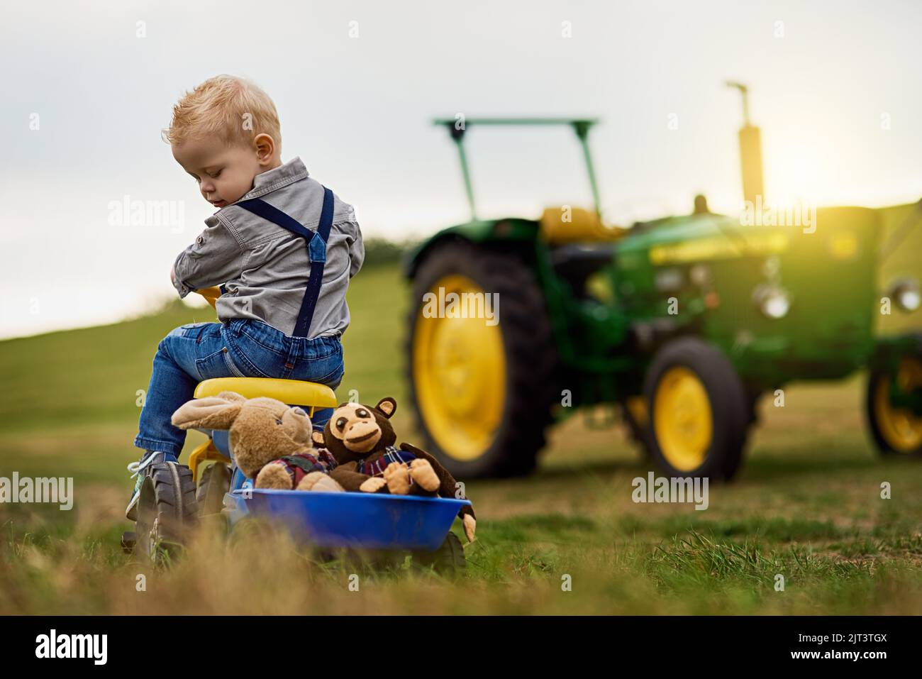 Learning about hard work the fun way. an adorable little boy carting