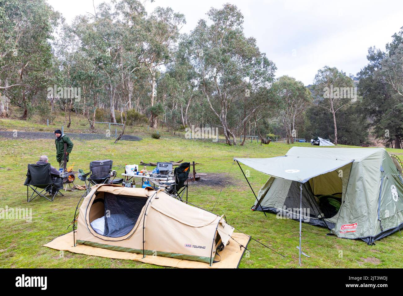 Two men at their australian campsite with swag and tent plus kitchen