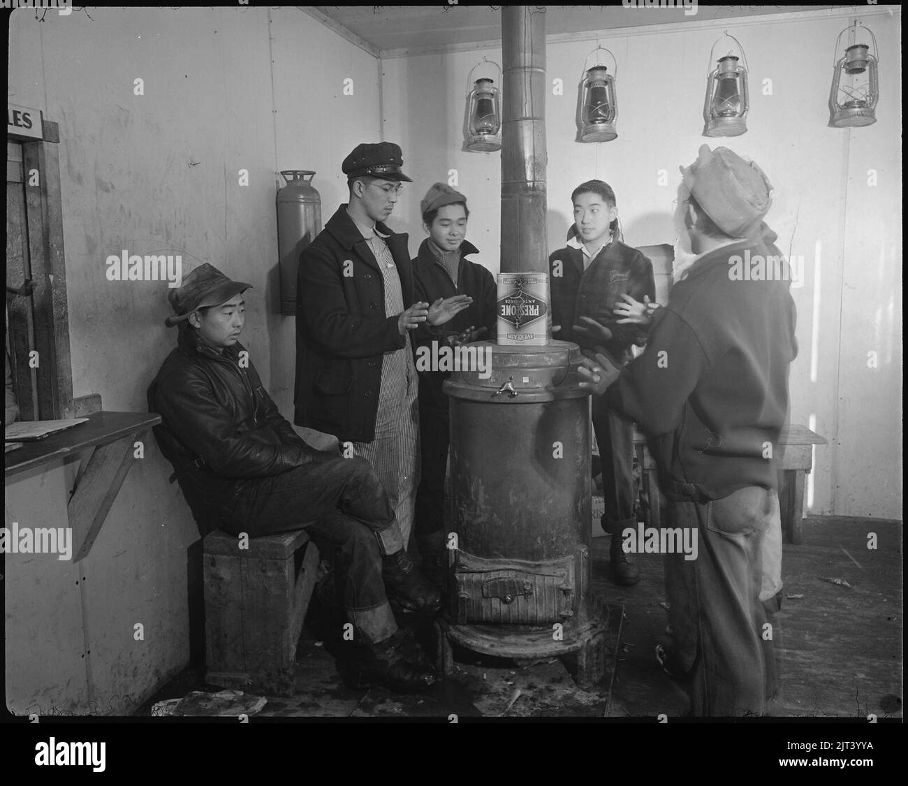 Tule Lake Relocation Center, Newell, California. A large iron stove is enjoyed on cold winter