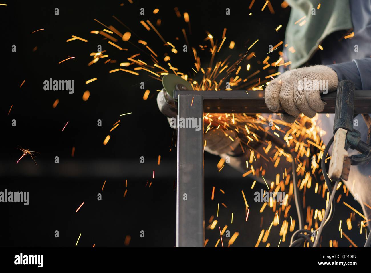 Worker triming steel balcony railing in construction site Stock Photo