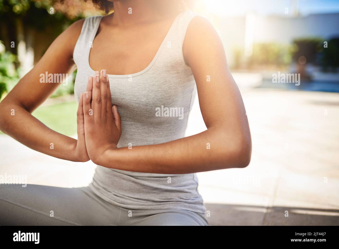 Keeping to her yoga routine. a sporty young woman practicing yoga outdoors. Stock Photo