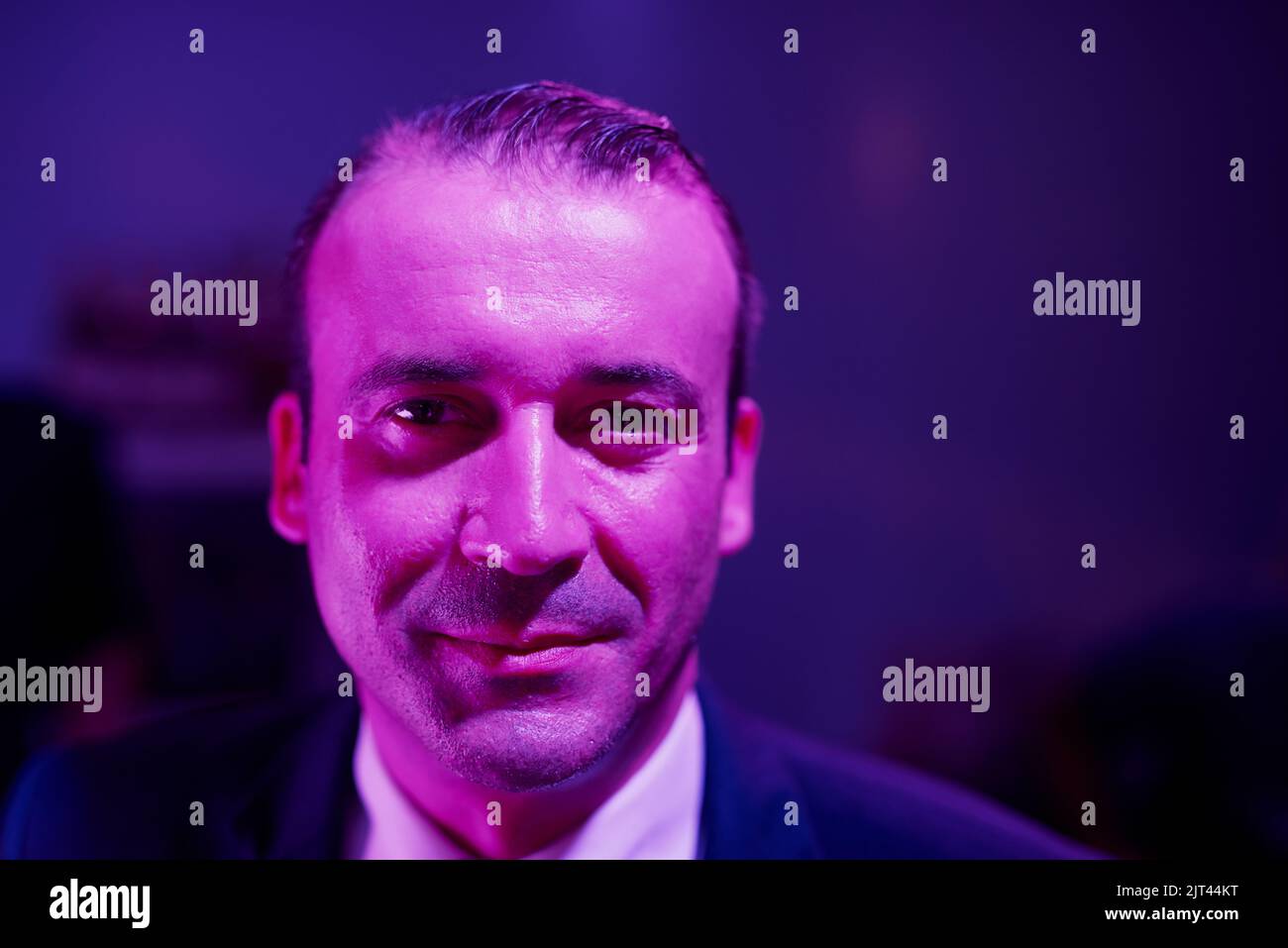 Meet Mr. Wrong. Portrait of a shady businessman sitting in a seedy Thai nightclub. Stock Photo