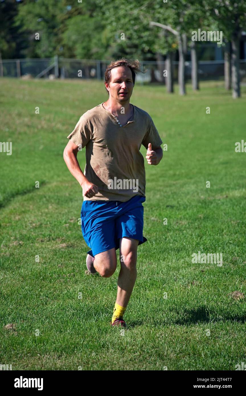 Mature man running in nature Stock Photo