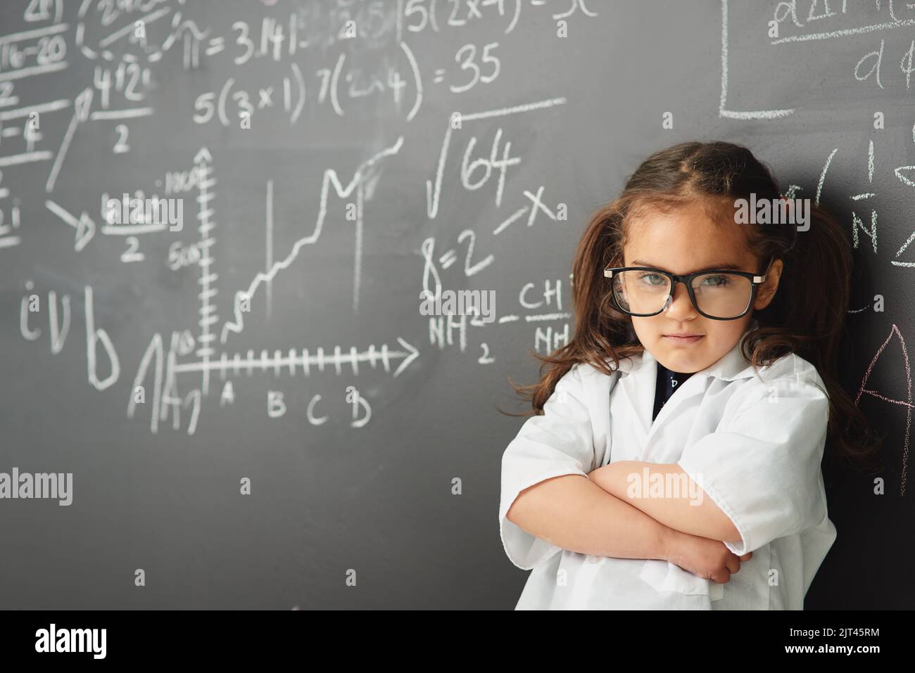 Shes a smarty pants. a young girl with a blackboard full of math ...
