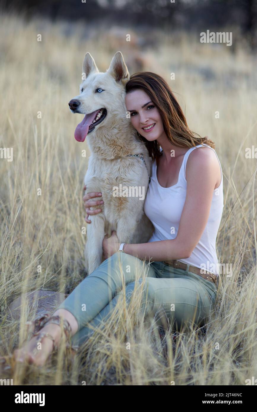Hes more than a pet. Hes family. Portrait of an attractive young woman bonding with her dog outdoors. Stock Photo