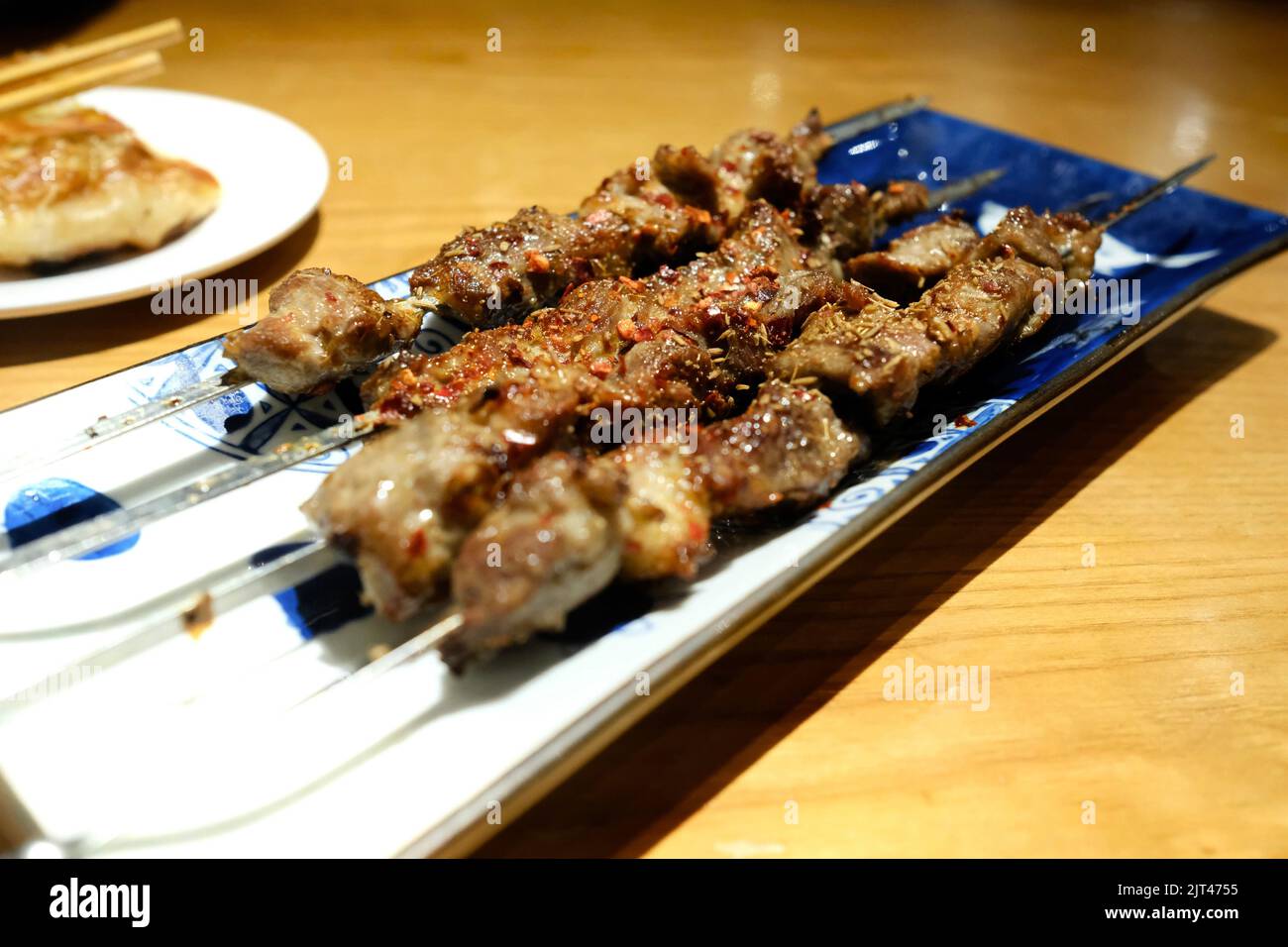 A plate of cumin lamb skewers at 1915 Lanzhou Beef Noodles — Burwood Chinatown; Sydney, Australia Stock Photo