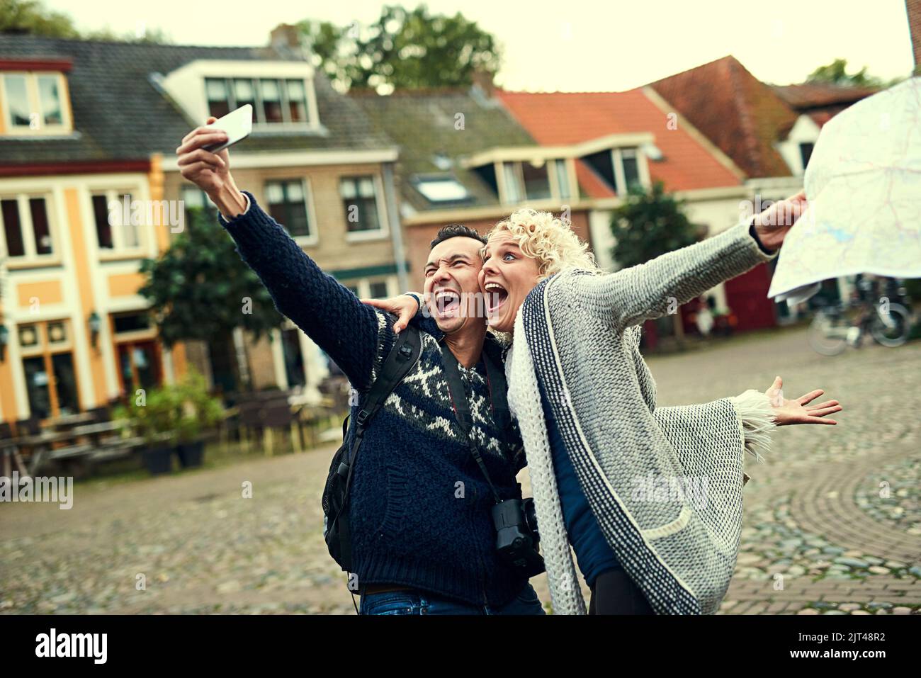 Taking crazy selfies. a young couple taking selfies while on vacation. Stock Photo