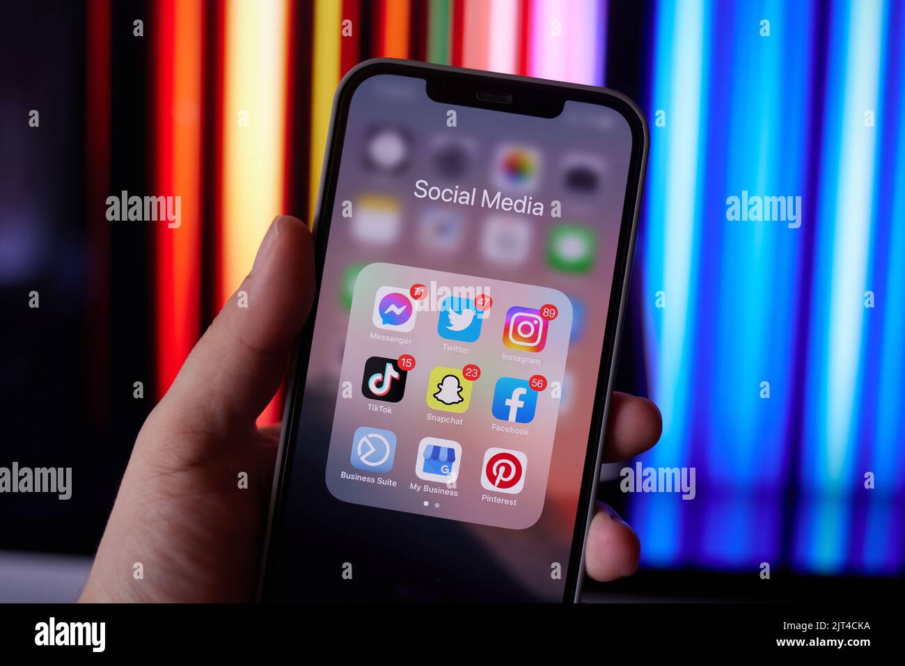 iPhone in Hand on Screen Group of Social Media apps and Notification