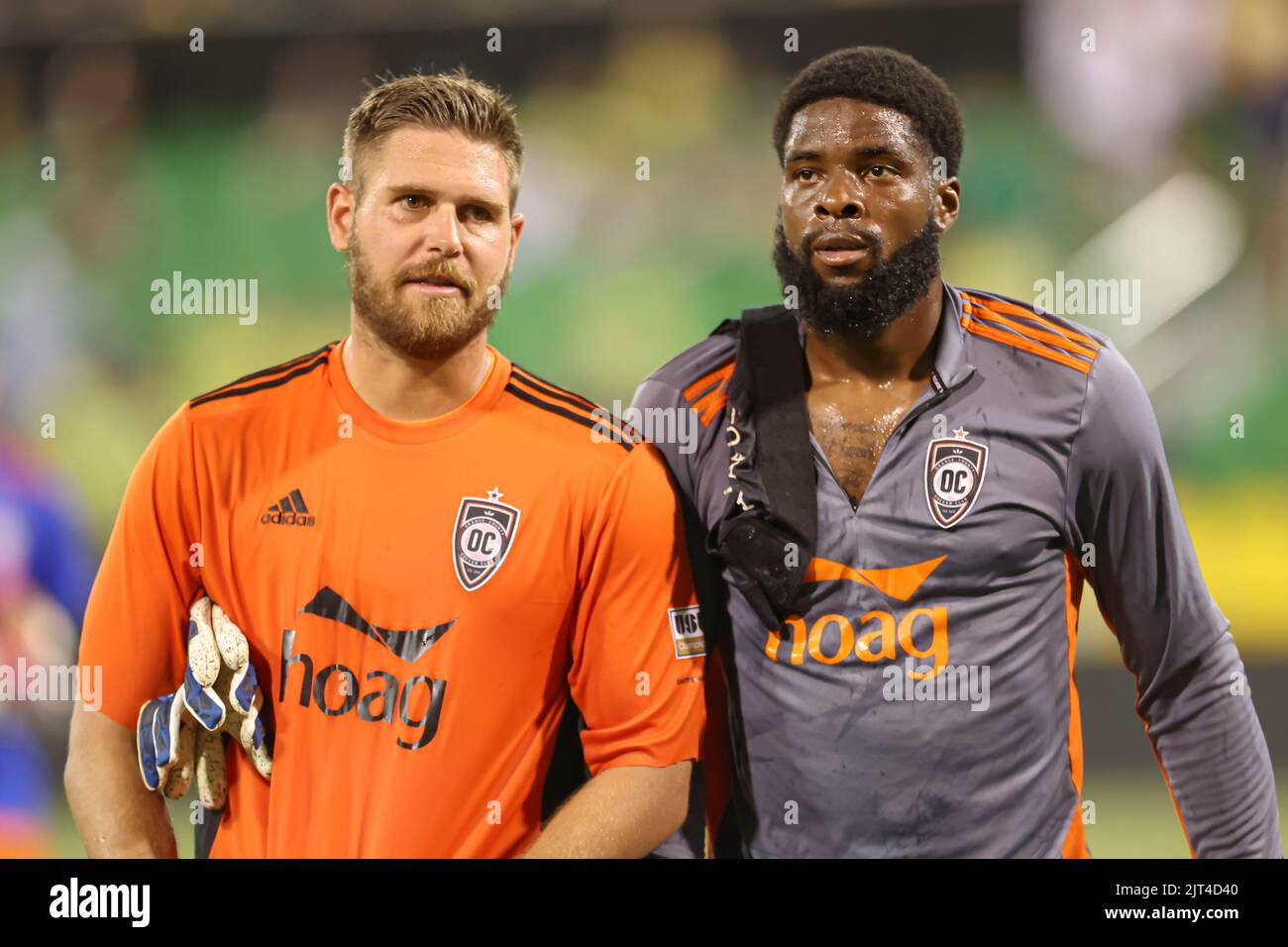 St. Petersburg, FL: Orange County SC goalkeeper Patrick Rakovsky (1) and forward Sean “Ugo” Okoli (19) head to the locker room after a USL soccer game Stock Photo