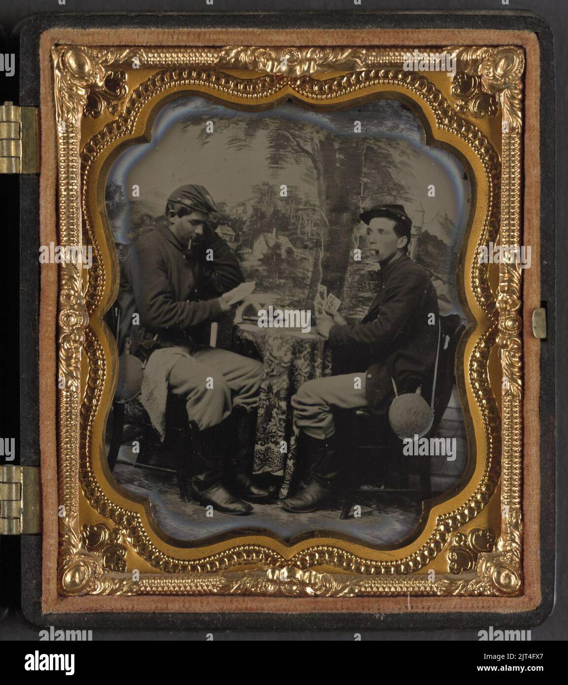 Two unidentified soldiers in Union uniforms with canteens playing cards ...