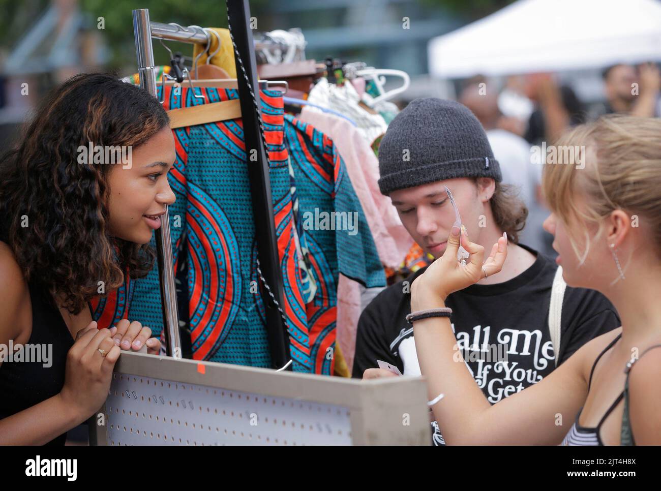 Vancouver, Canada. 27th Aug, 2022. Customers view handmade ornaments at a vendor's booth during the Black Block Party, an event organized by local black community, in Vancouver, British Columbia, Canada, on Aug. 27, 2022. Credit: Liang Sen/Xinhua/Alamy Live News Stock Photo