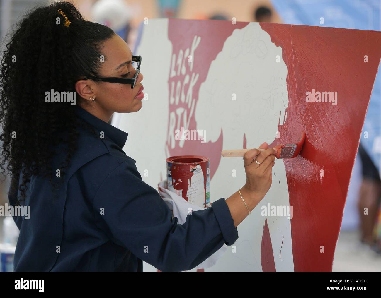 Vancouver, Canada. 27th Aug, 2022. An artist works on her painting during the Black Block Party, an event organized by local black community, in Vancouver, British Columbia, Canada, on Aug. 27, 2022. Credit: Liang Sen/Xinhua/Alamy Live News Stock Photo