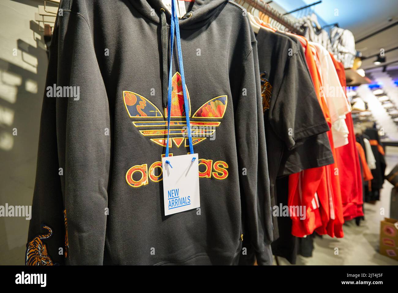 SINGAPORE - CIRCA JANUARY, 2020: clothes on display at Adidas store in Singapore Changi Airport. Stock Photo