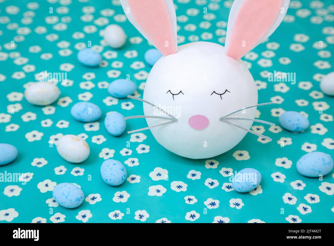 A bunny head with blue and white chocolate eggs Stock Photo
