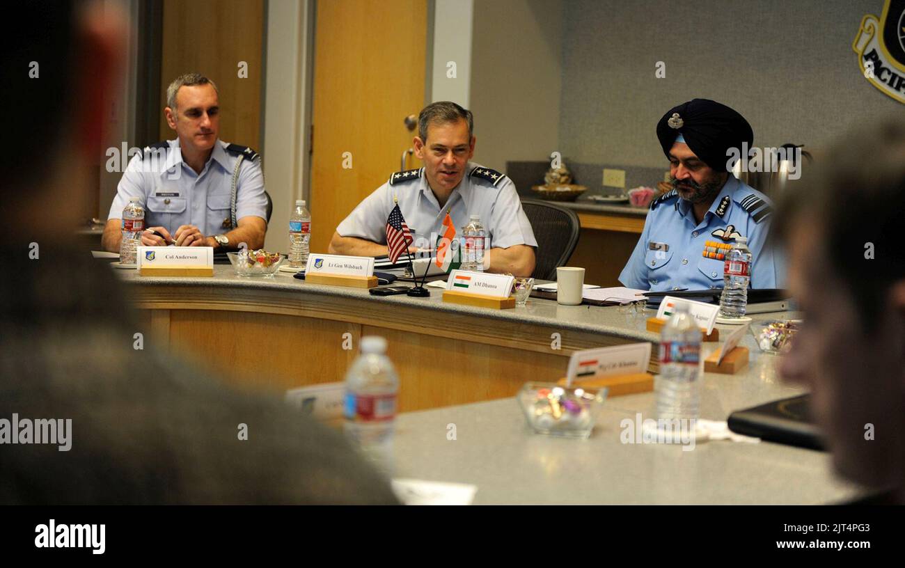 U.S. Air Force Lt. Gen. Kenneth Wilsbach, seated with Indian Force Air Marshal Birender Dhanoa, issues his opening remarks, officially beginning the first day of the Executive Steering Group. Stock Photo